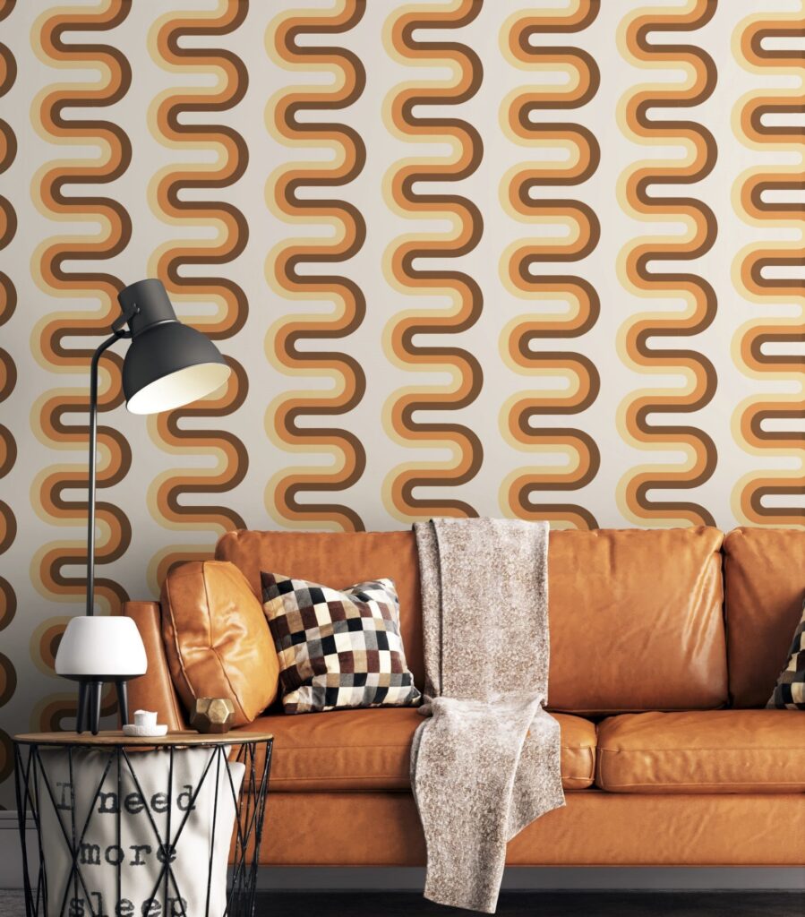 Retro 70s house interior with orange leather sofa and patterned wallpaper