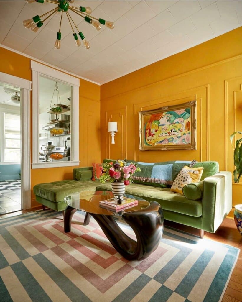 Modern retro living room with Dutch Orange walls, green velvet sofa, sculptural glass coffee table and Sputnik pendant light
