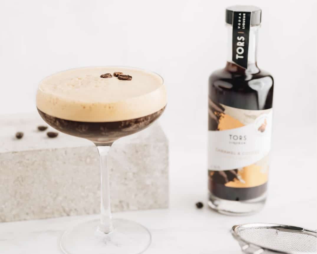 TORS Caramel and Coffee Liqueur bottle beside a caramel espresso martini