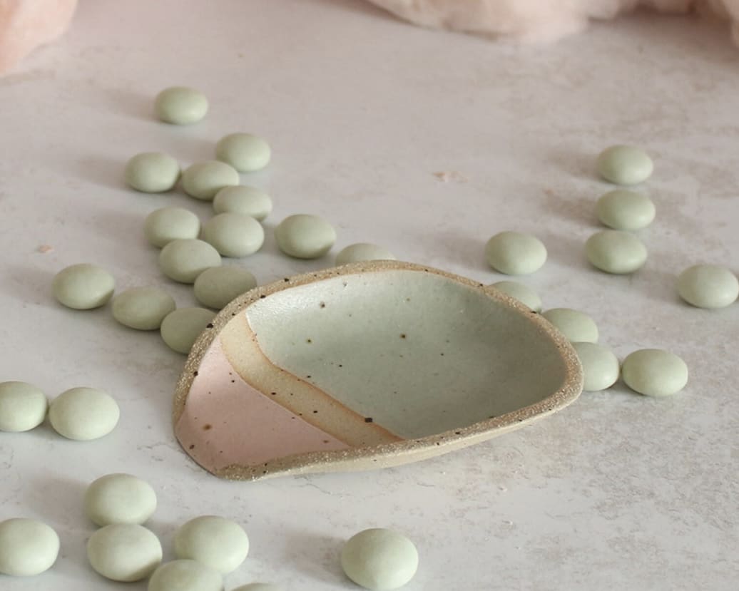 Handmade ceramic spoon rest in pastel pink and mint