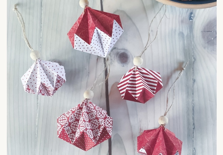 Red and white origami diamond ornaments hanging on twine