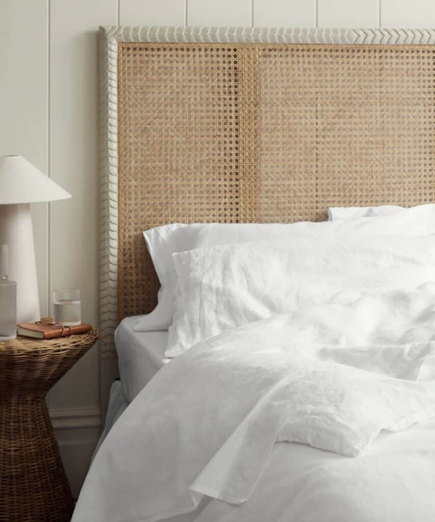 Cosy guest room ideas with white linen bedding and rattan headboard – how to make a guest room cosy and inviting