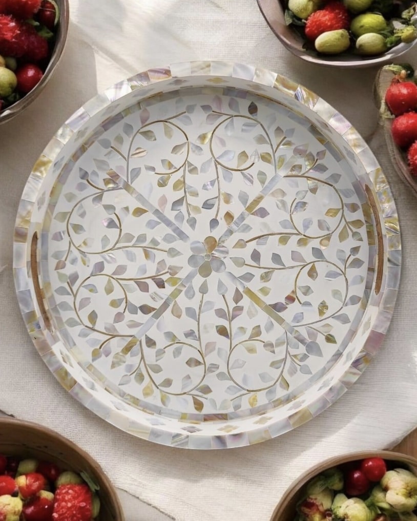 Round white mother of pearl inlay tray styled with fruit bowls