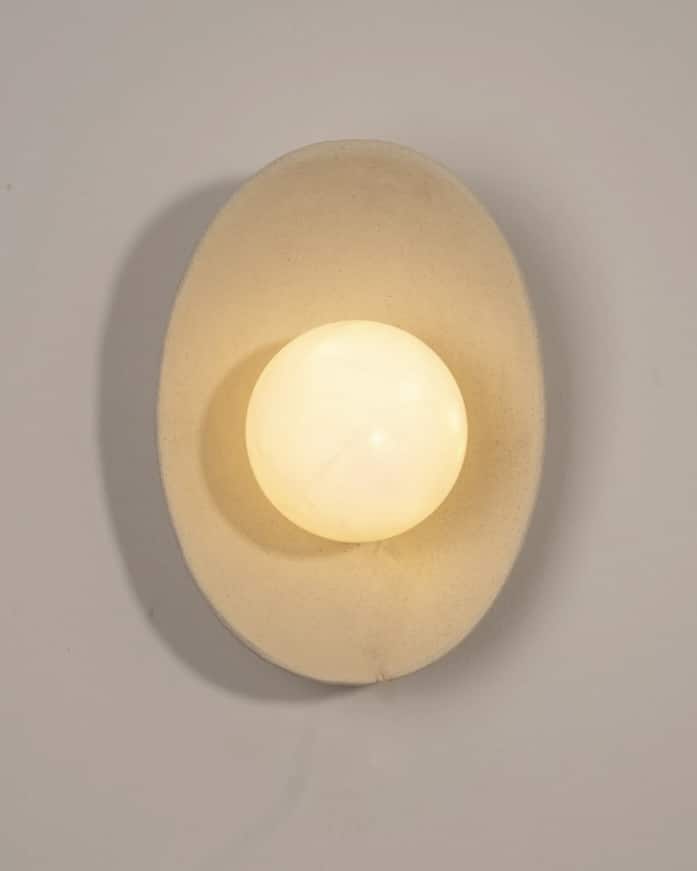 Handcrafted ceramic wall sconce in warm beige tones