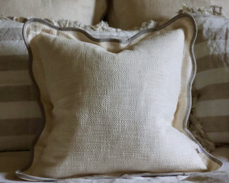 Chloe cream and greige scalloped edge cushion adding soft structure to a beige bedroom