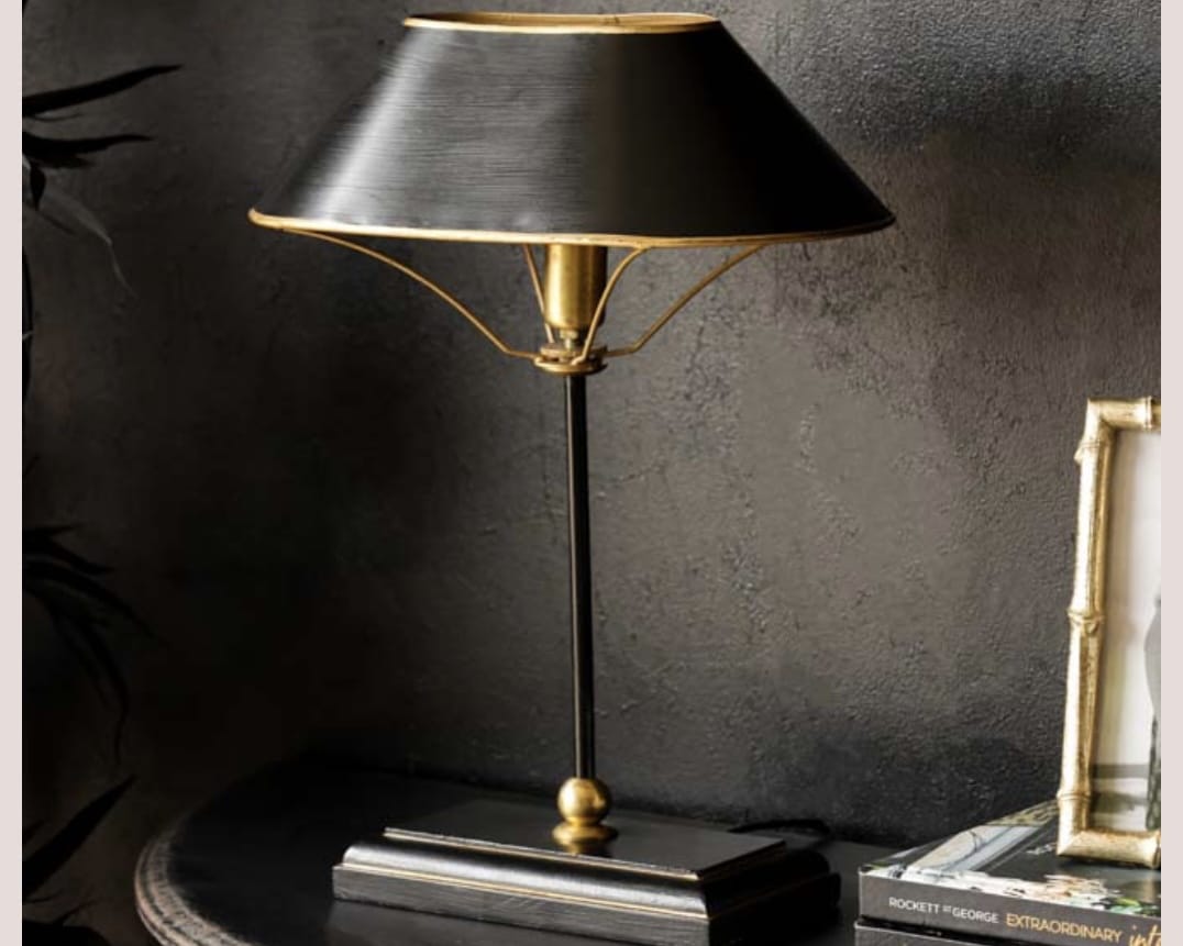 Black and gold table lamp for a beige and black bedroom
