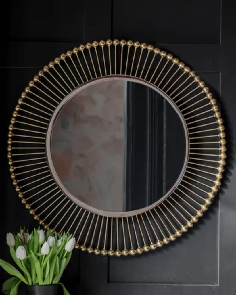 Gold sunburst round mirror for above the bed