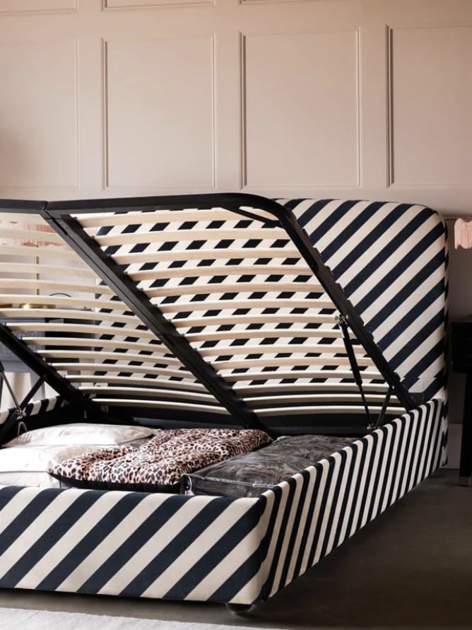 Striped Jagger ottoman bed with black bedding and pink cushions