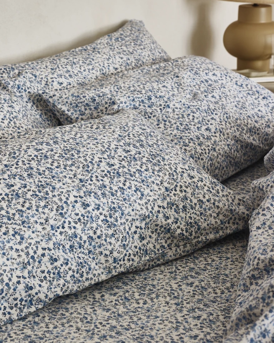 Blue floral bedding for a layered blue bedroom