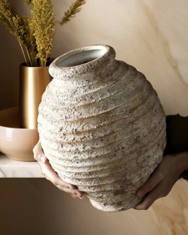 Rustic textured ceramic vase in a pale stone finish.