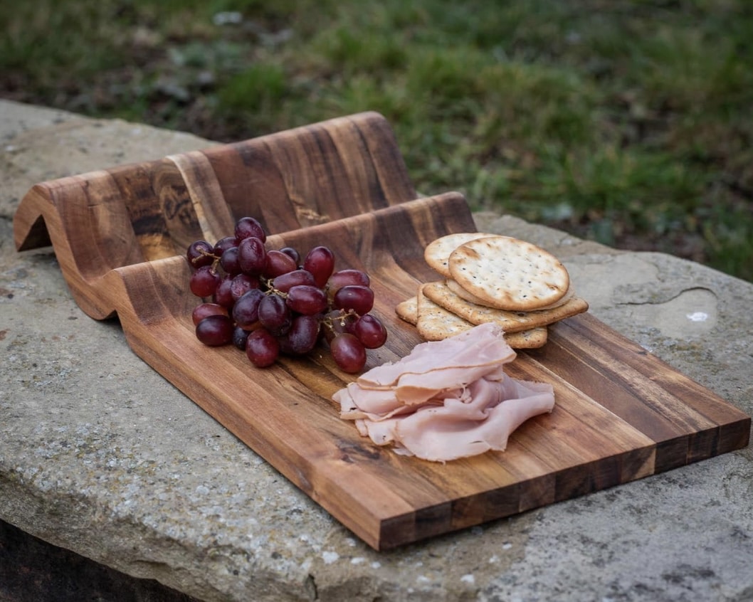 Handcrafted acacia wood charcuterie board with sculpted wave detail
