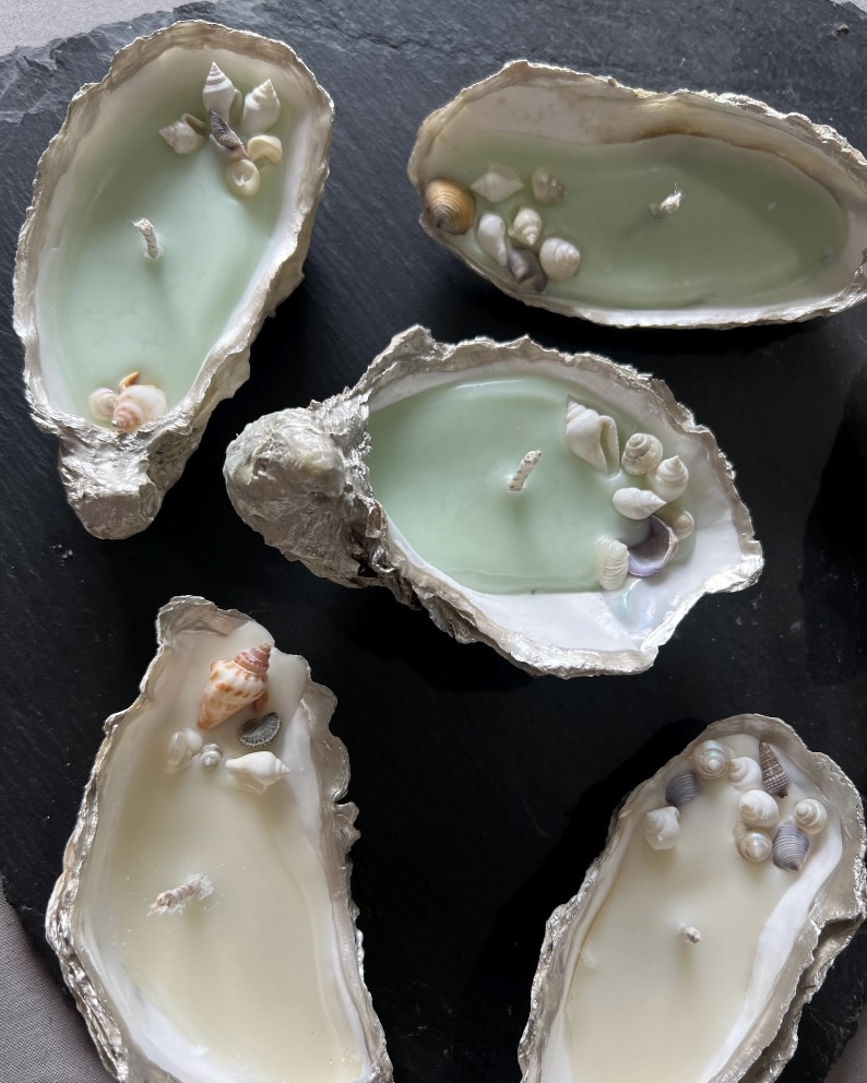Handmade oyster shell candles with tiny seashells for coastal table decor
