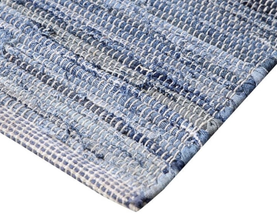 Blue denim chindi rag rug adding relaxed texture to a coastal living room