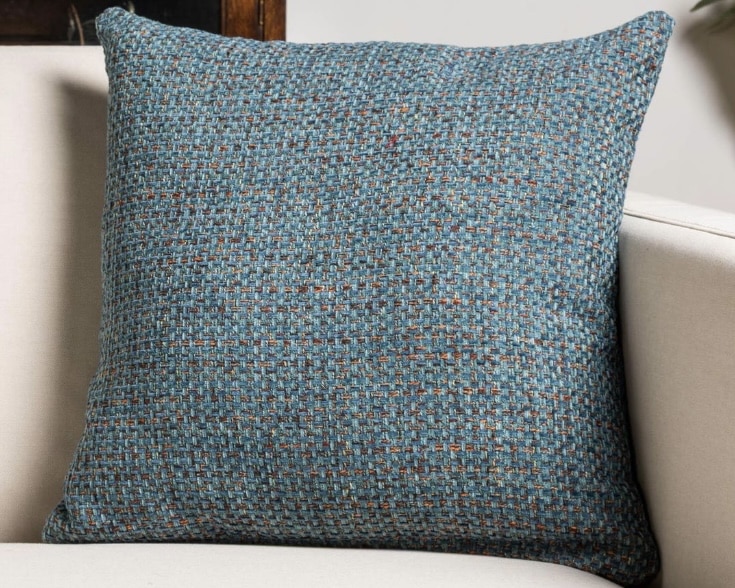 Teal textured basketweave cushion on a neutral sofa