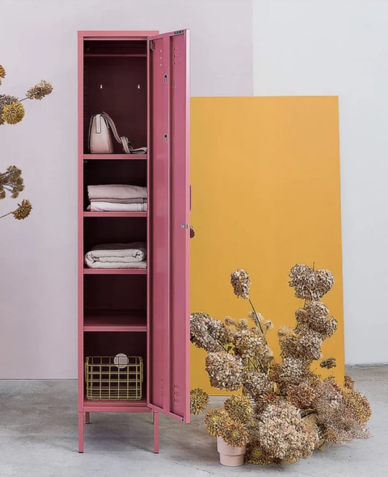 Small bedroom storage idea: Mustard Made Skinny Locker in blush pink, a slim vertical locker cabinet for folded bedding and accessories.