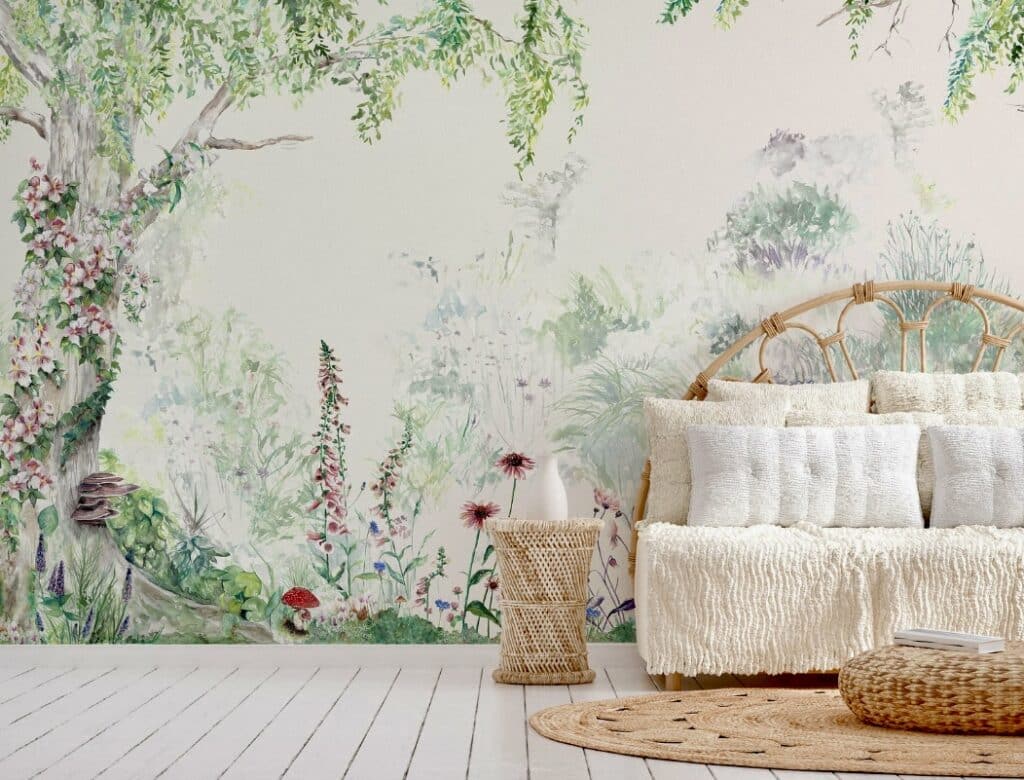 Flower forest mural style wallpaper creating a dreamy botanical feature wall behind a rattan daybed with cream cushions and woven rug – calming bedroom wallpaper ideas.