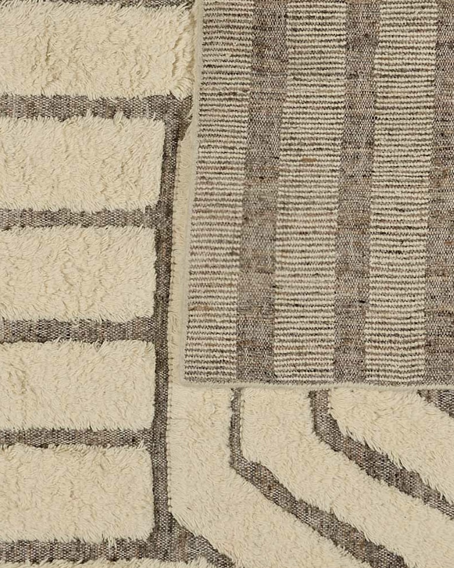 Beige and taupe abstract patterned shaggy wool rug photographed flat