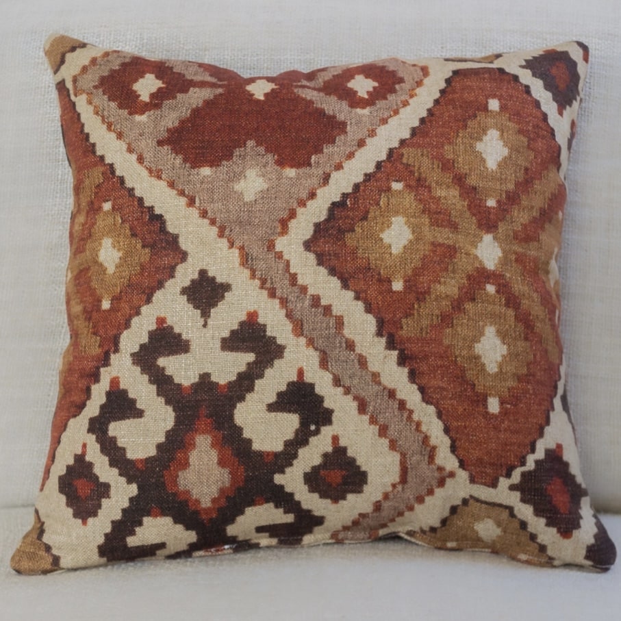 Terracotta kilim style patterned cushion with warm rust and cream tones