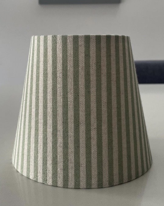 Rattan wall light with pleated shade