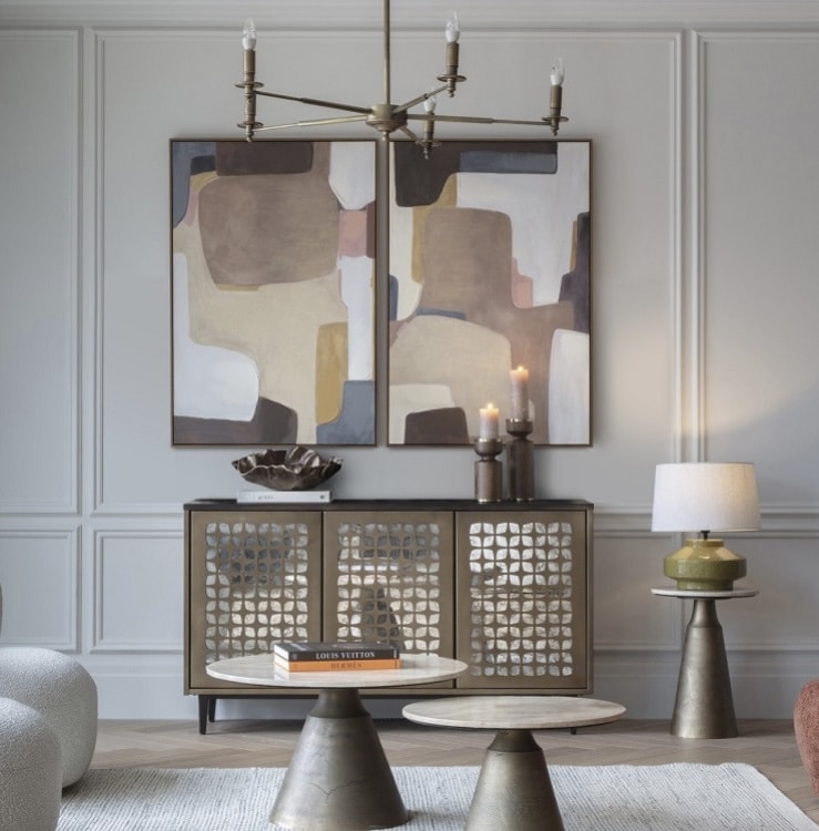 Living room lighting layers with a ceiling chandelier and green table lamp on a side table (4Living).