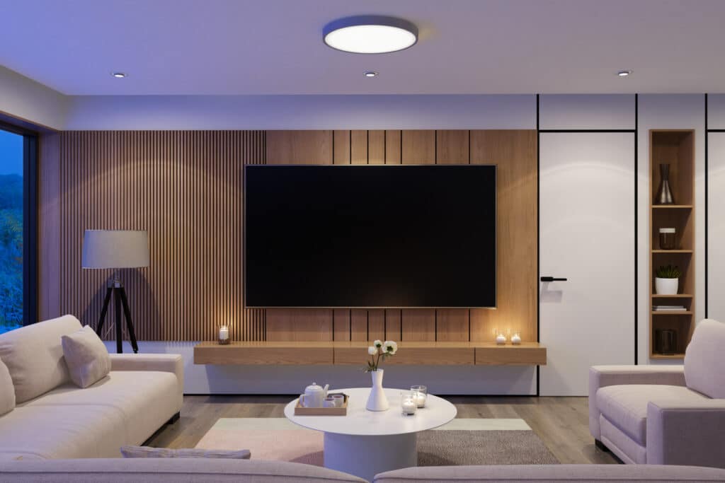 Modern living room with wood panel TV wall and LED lights behind the TV, showing soft living room LED lighting for a warm glow.
