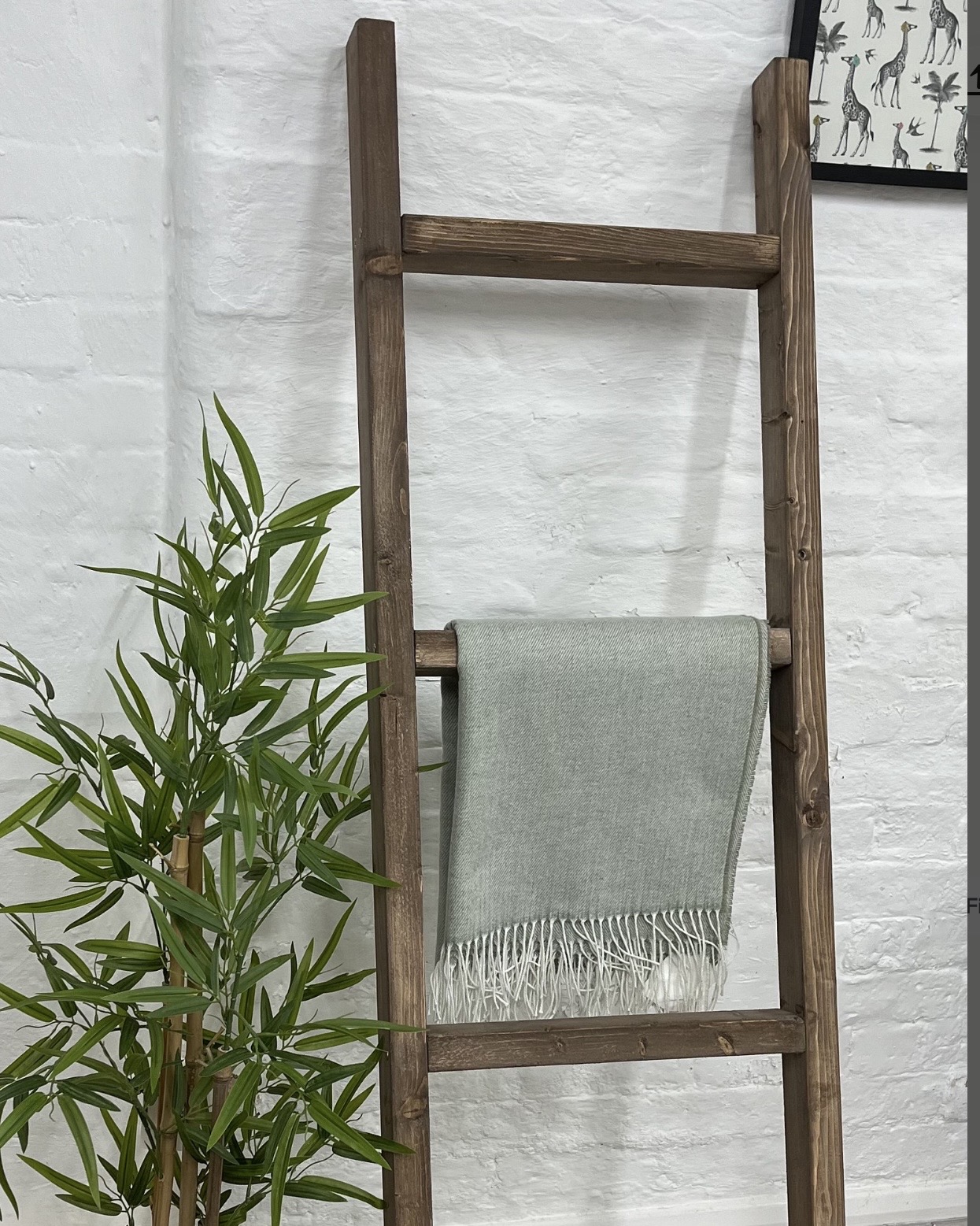 Dark rustic wooden towel ladder for a neutral bathroom