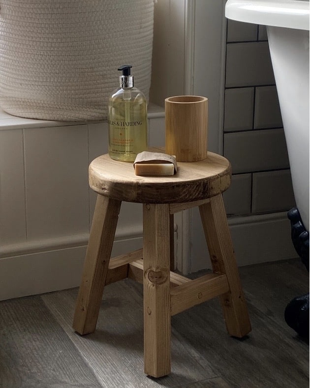 Rustic wooden stool for a neutral bathroom