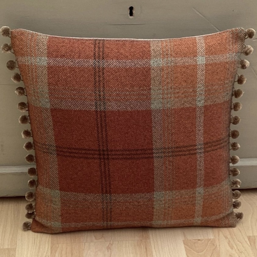 Burnt orange tartan tweed cushion with bobble trim