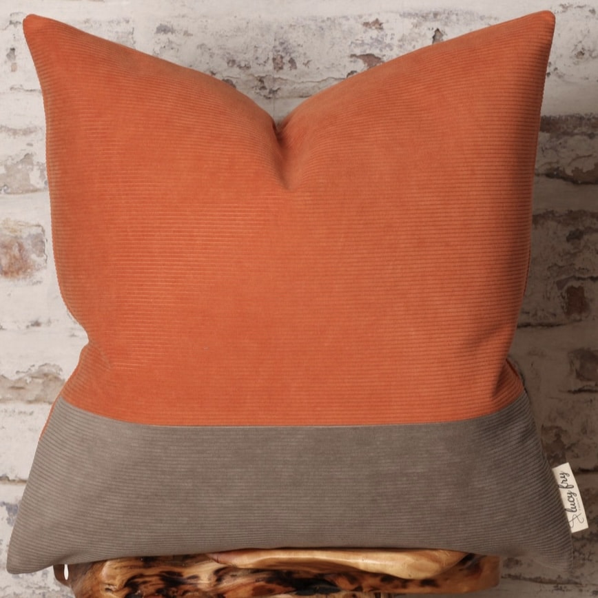 Colour-block corduroy cushion in burnt orange and warm taupe
