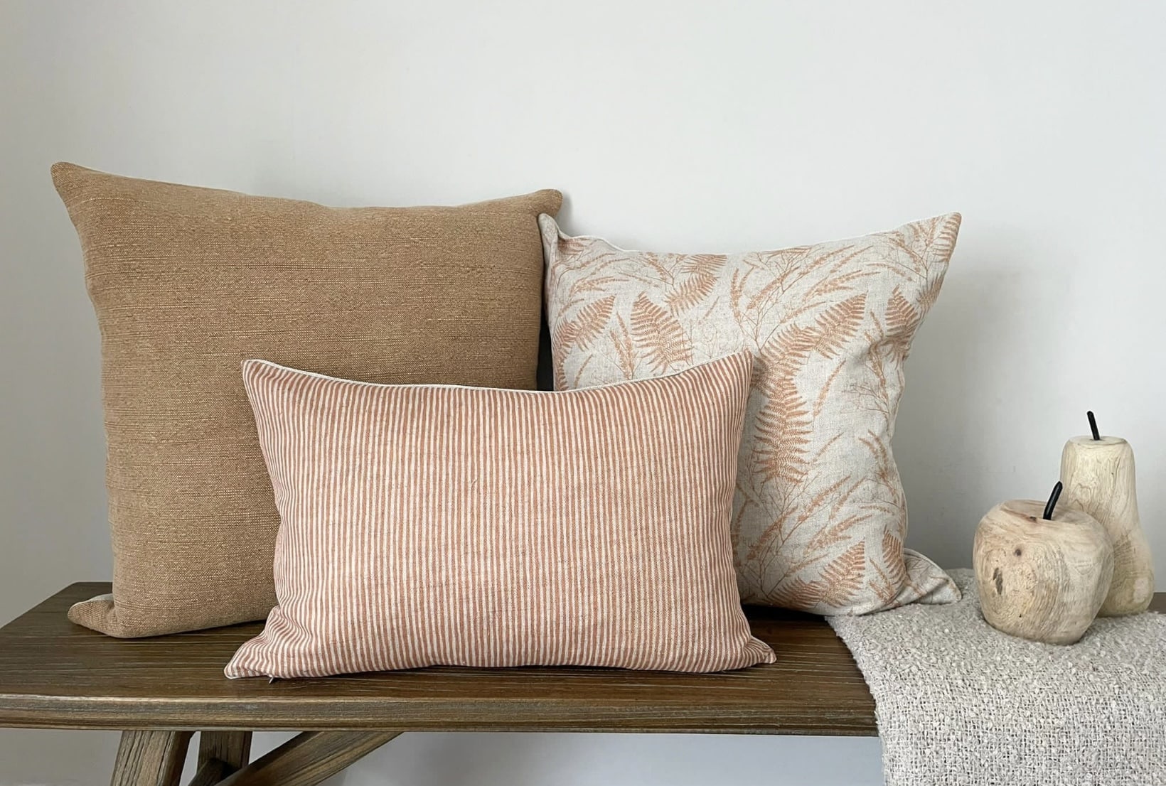 Orange cushions styled on a neutral sofa for warm living room ideas