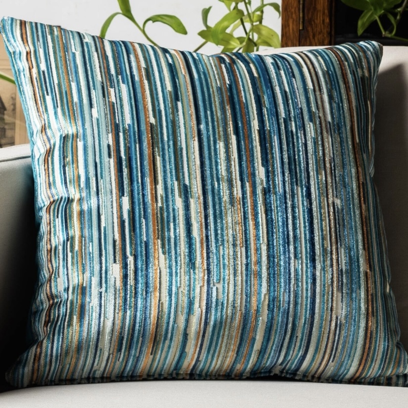 Teal stripe velour cushion with warm neutral accents