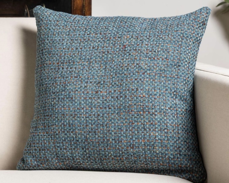 Teal textured cushion cover to add depth and a tactile finish to an orange and blue living room