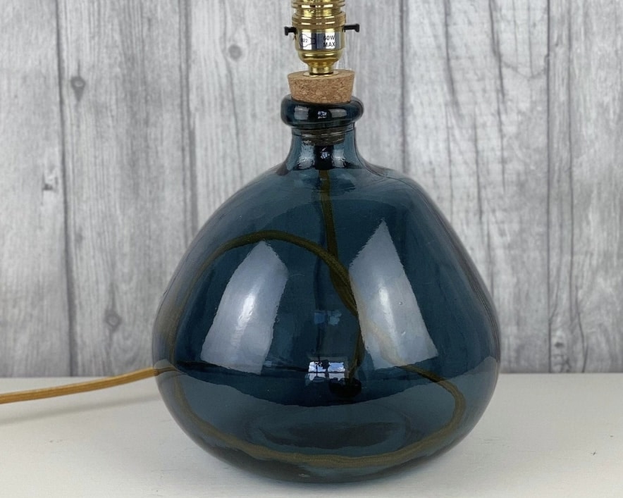 Deep blue recycled glass lamp base to bring a glossy accent into an orange living room