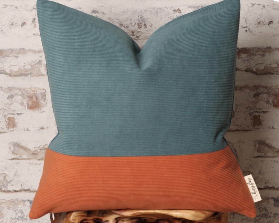 Teal and burnt orange cushion cover to tie orange upholstery into blue accessories