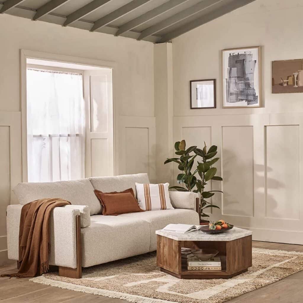 neutral living room with rust and striped orange pattern cushions on cream sofa with wooden coffee table