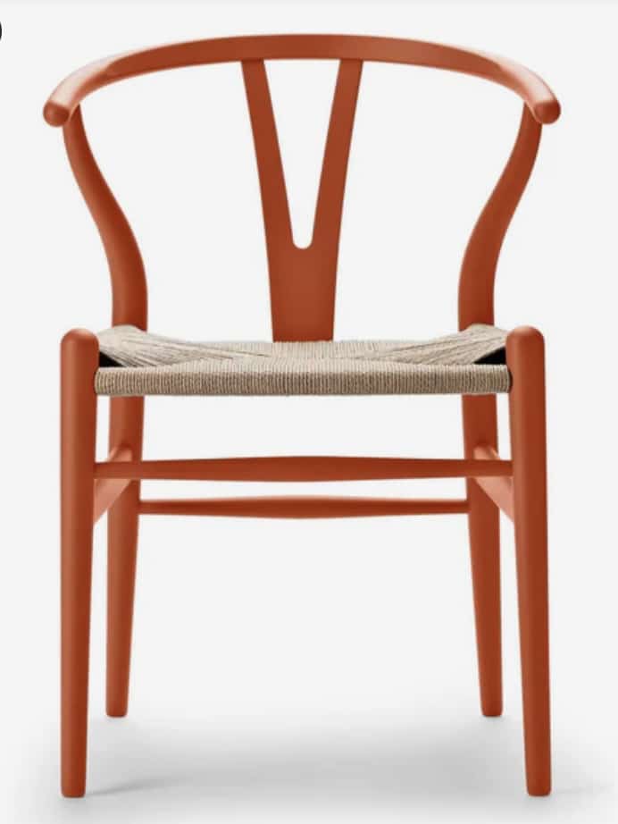 Orange dining chair to add warmth in a beige sofa living room