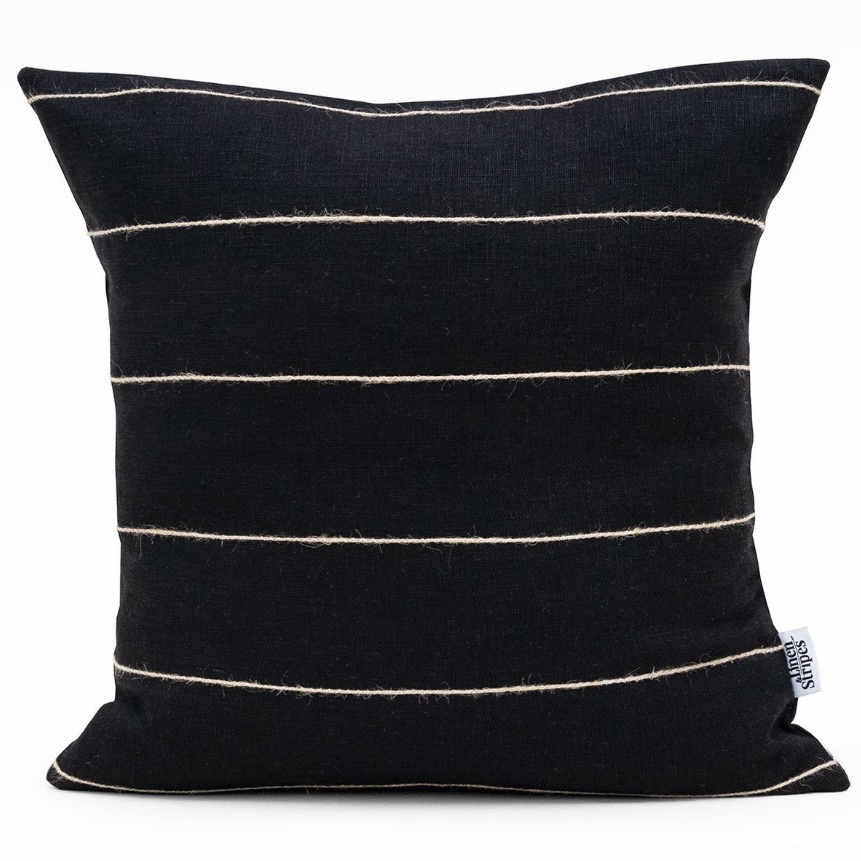 Tan leather sofa cushions — black linen cushion with jute stripes for contrast