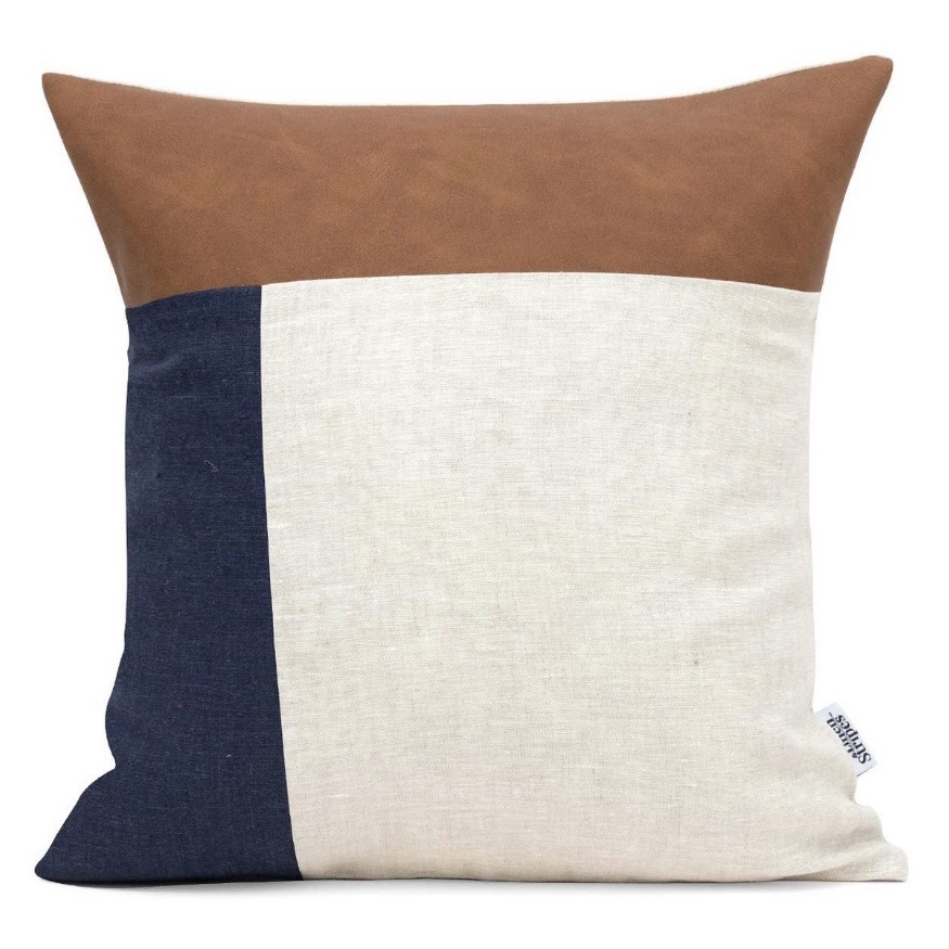 Colour-block cushion in tan, navy and cream — ties leather, neutrals and blue together