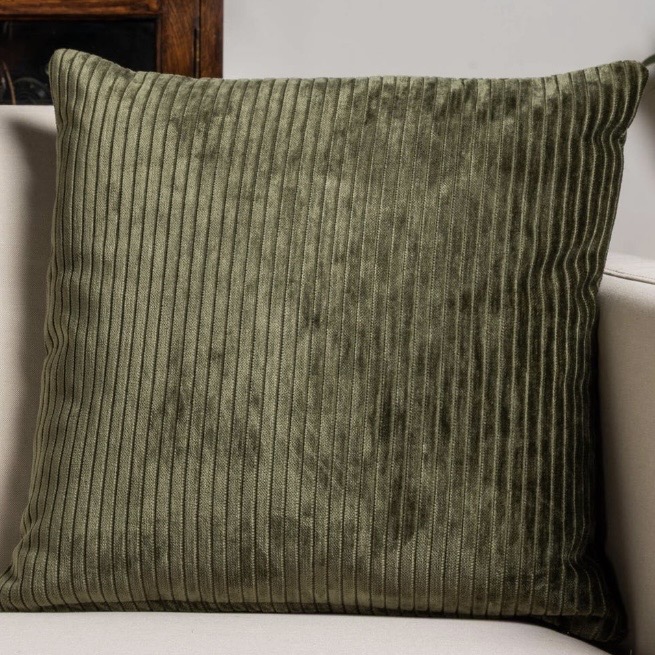 Olive green jumbo corduroy cushion — cosy ribbed texture for a tan leather sofa