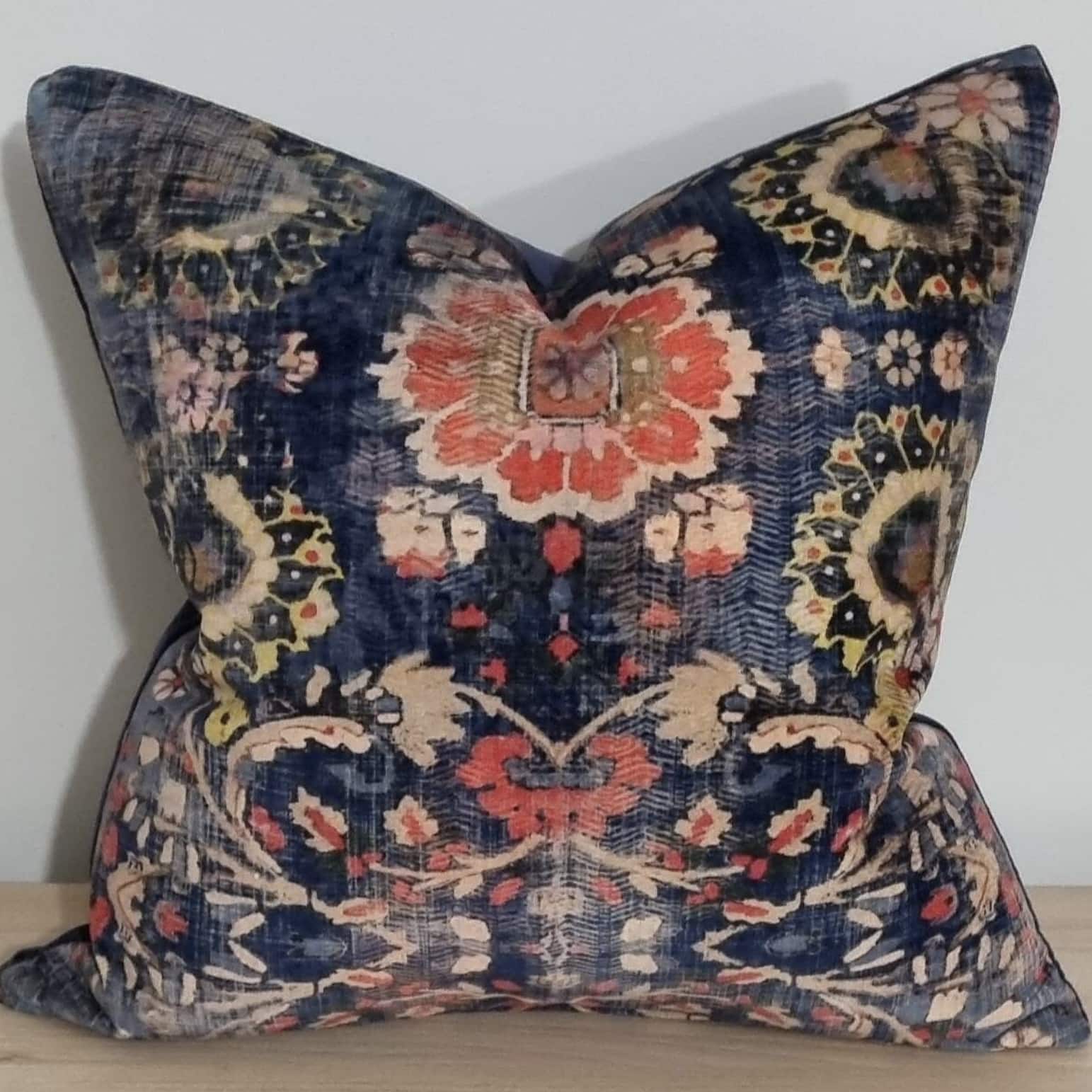 Navy patterned cushion with rust, cream and floral details