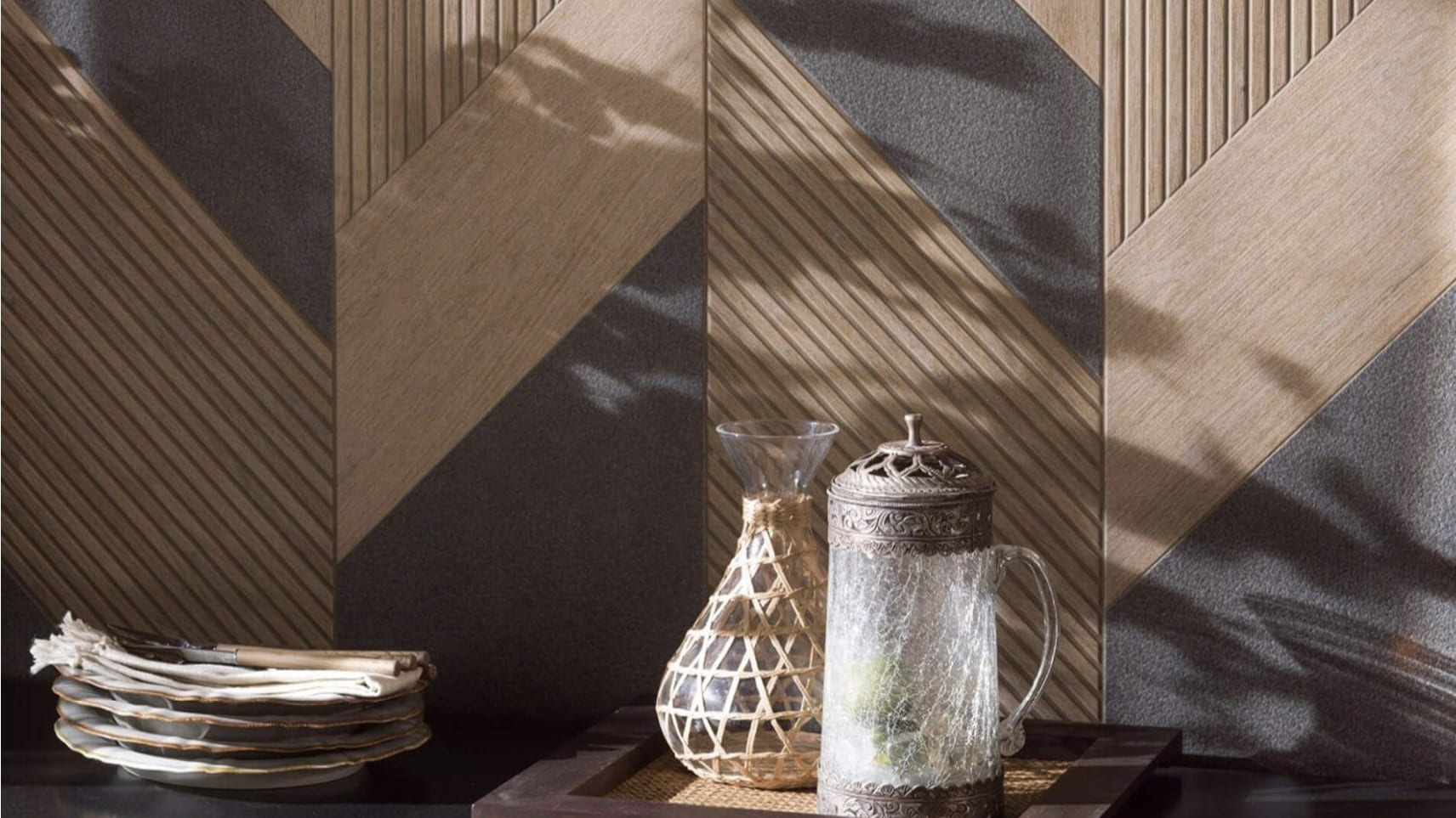 Porcelanosa kitchen tiles in an architectural geometric pattern with warm wood and charcoal tones