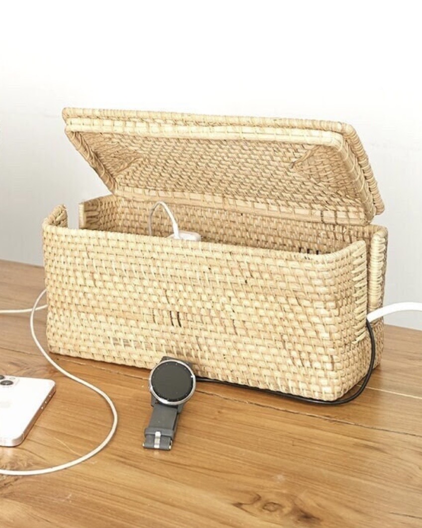 Woven rattan cable management organiser box hiding extension leads, a tidy solution for living room storage ideas and a calmer TV unit.