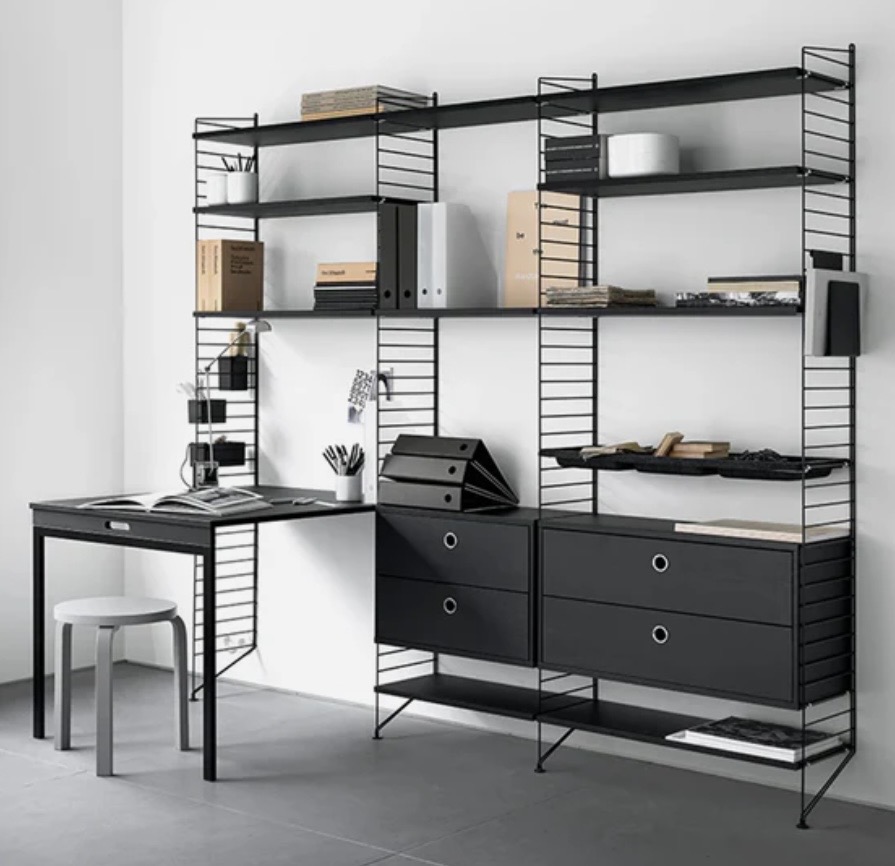 Modern home office with String shelving system and slim desk, showing open storage and clean-lined furniture.