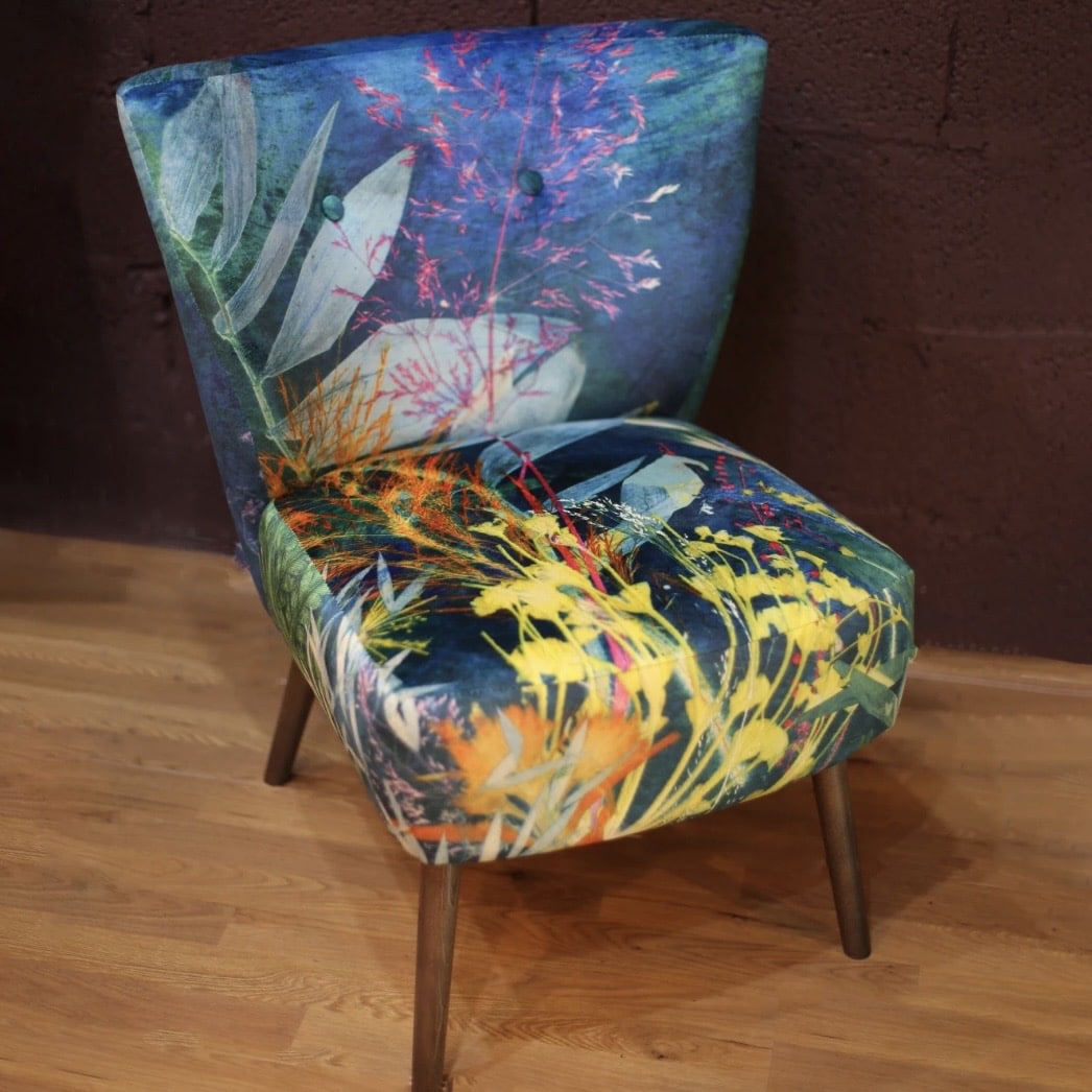 Aqua blue velvet cocktail chair with colourful painterly botanical pattern
