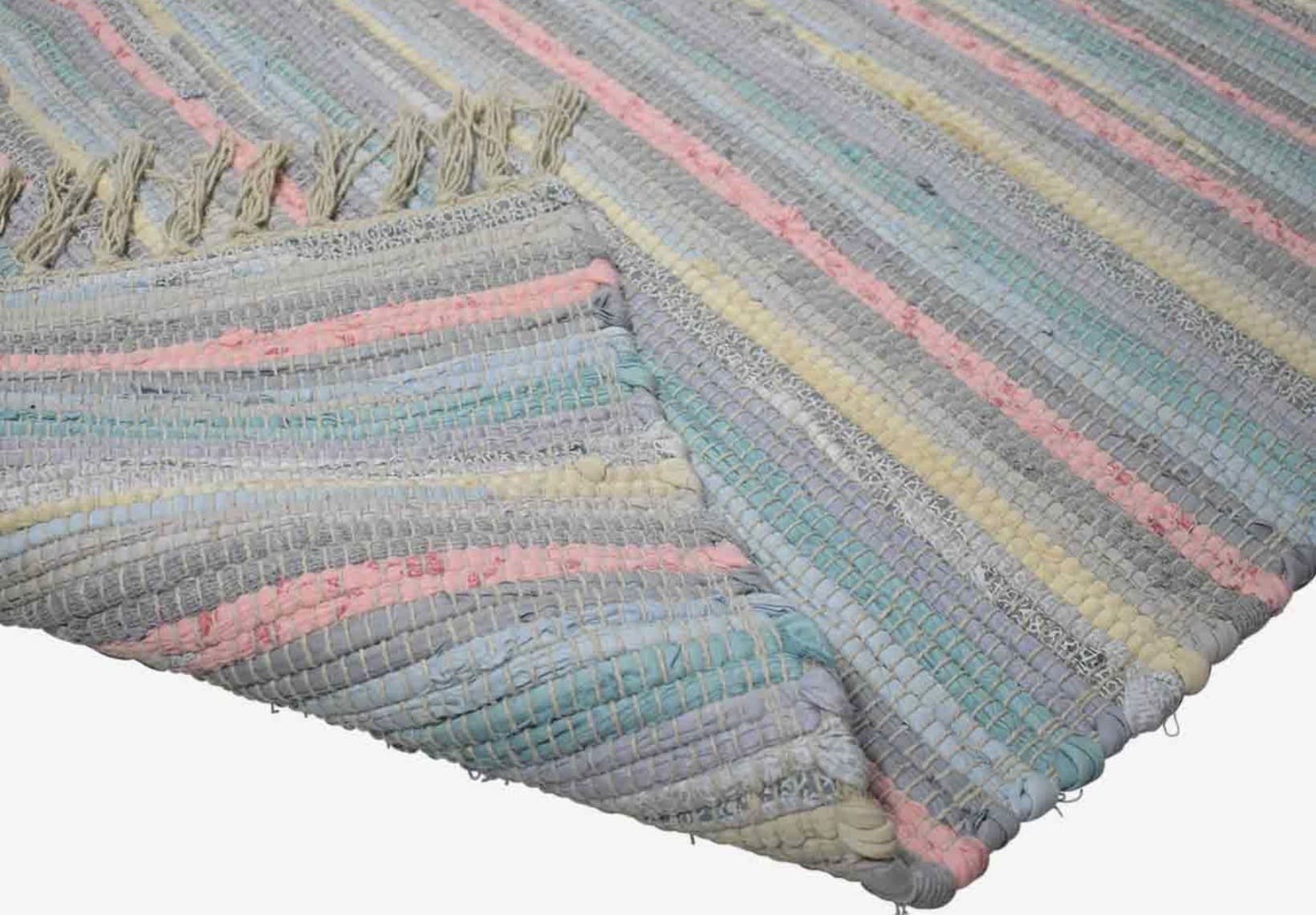 Soft pastel rag rug with subtle stripes, a cosy handmade floor covering for a child’s bedroom