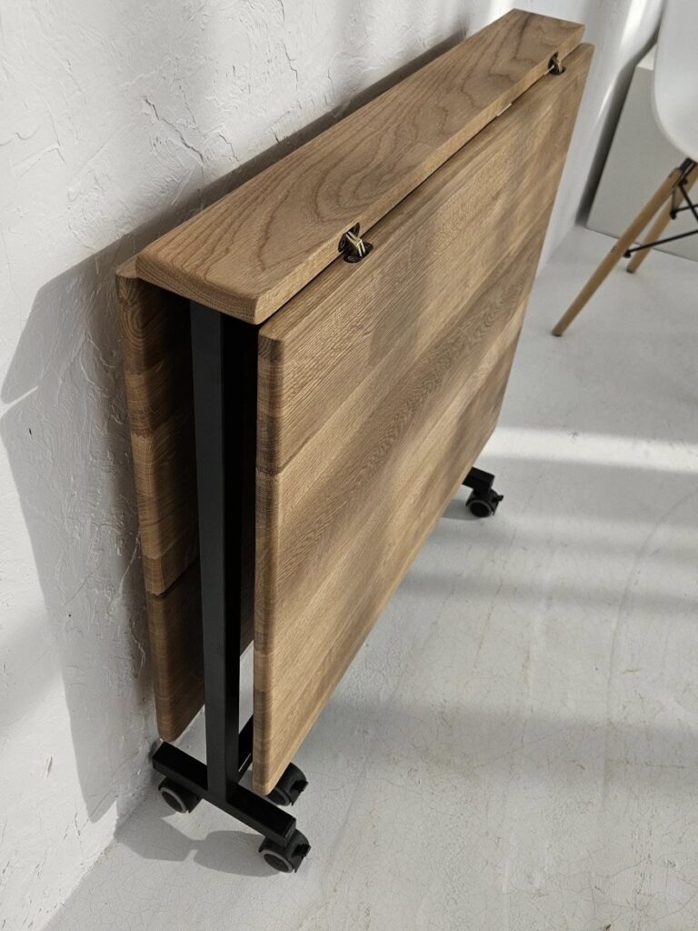 Small dining room ideas: space-saving oak drop-leaf table on wheels folded away against the wall.