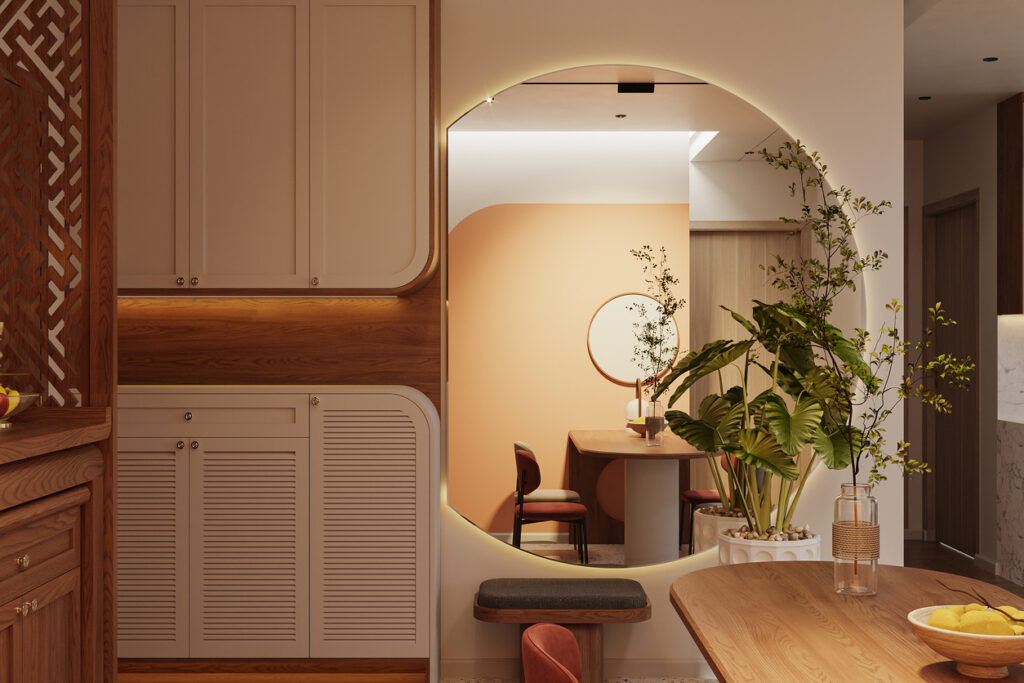 Small dining room ideas: oversized mirror reflects a warm, compact dining nook, making the space feel bigger with soft lighting and natural wood cabinetry.