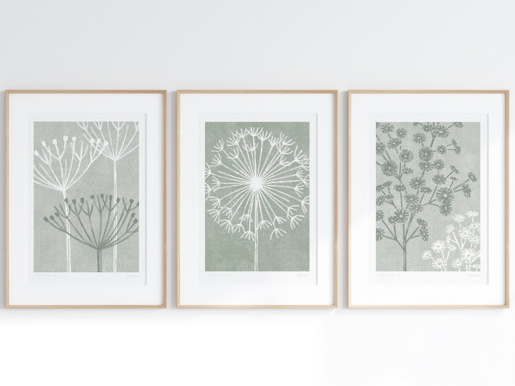 Set of three sage green botanical prints in light wood frames