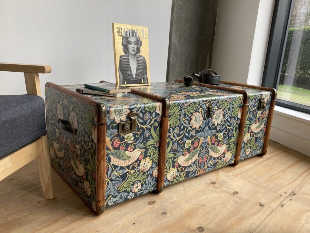 William Morris Strawberry Thief steamer trunk coffee table with hidden storage for toys and blankets in a living room