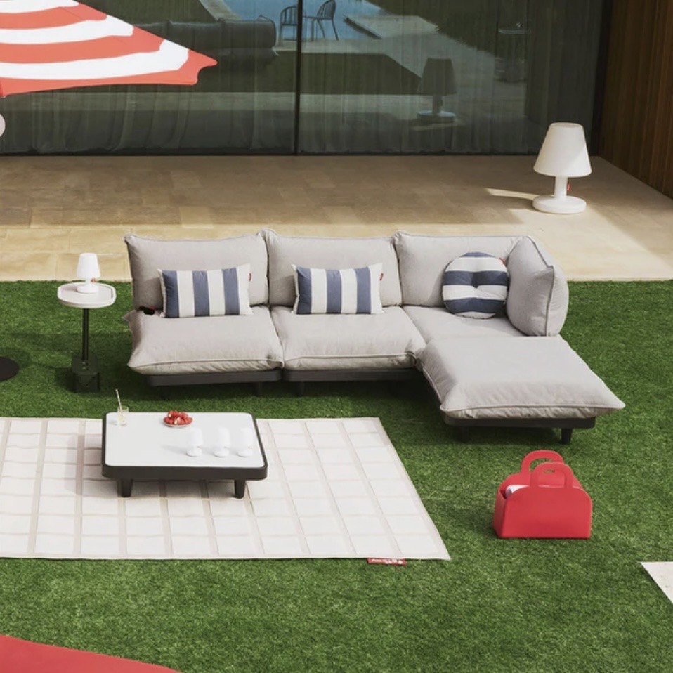Modern modular corner garden sofa with low table on a contemporary patio